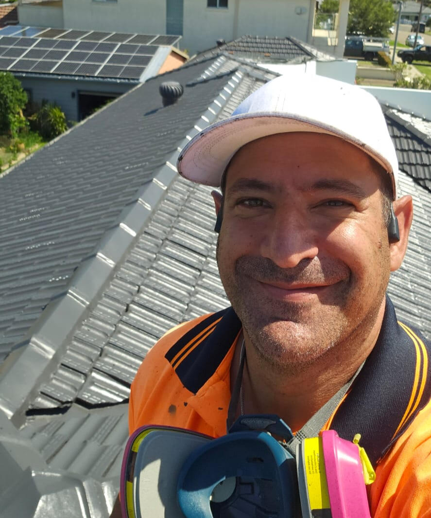Klean Kingdom owner on a freshly restored terracotta roof coated in Monument colour, Kogarah Bay, Sydney